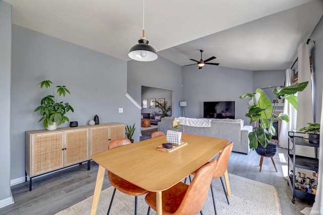 3063 N Natasha Dr, Bloomington, IN 47404 - dining room with light wood-style floors, a ceiling fan, vaulted ceiling, and baseboards