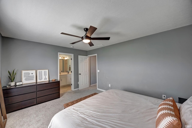3063 N Natasha Dr, Bloomington, IN 47404 - carpeted bedroom featuring ensuite bath, ceiling fan, and baseboards
