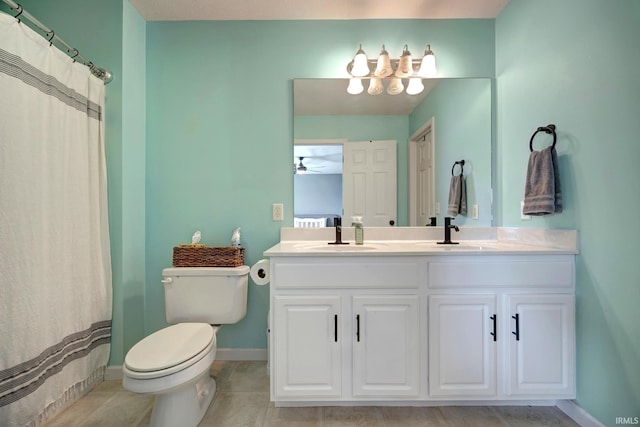 3063 N Natasha Dr, Bloomington, IN 47404 - full bath with toilet, double vanity, baseboards, tile patterned flooring, and a ceiling fan