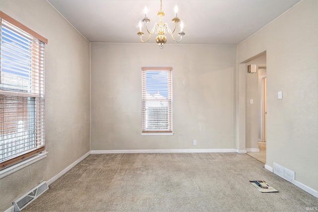 715 W 7th St, Mishawaka, IN 46544 - carpeted spare room featuring a chandelier, healthy amount of natural light, and baseboards
