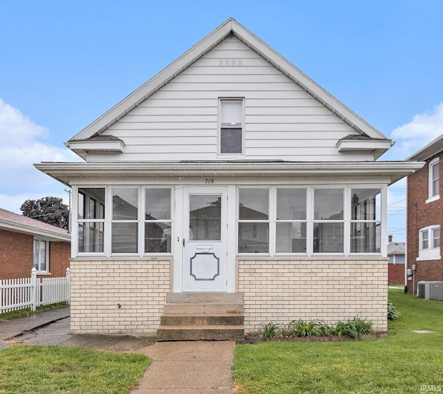 715 W 7th St, Mishawaka, IN 46544 - bungalow-style house with entry steps, brick siding, a sunroom, and central AC