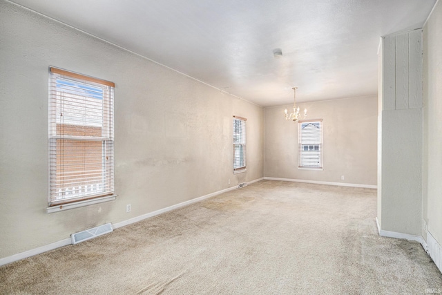 715 W 7th St, Mishawaka, IN 46544 - carpeted empty room featuring a chandelier and baseboards