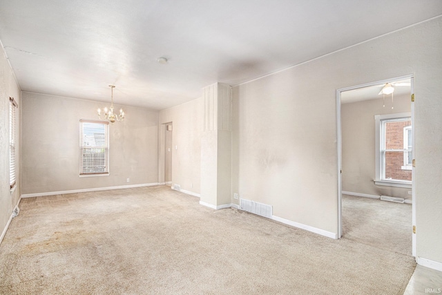 715 W 7th St, Mishawaka, IN 46544 - empty room featuring a chandelier, carpet, and baseboards