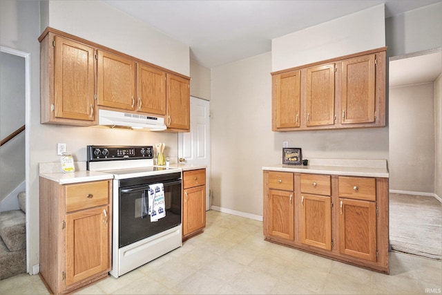 715 W 7th St, Mishawaka, IN 46544 - kitchen featuring white range with electric cooktop, under cabinet range hood, light countertops, and baseboards