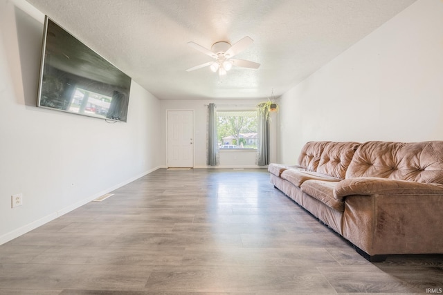 1422 Tam-O-Shanter Ln, Kokomo, IN 46902 - living room with ceiling fan, baseboards, wood finished floors, and a textured ceiling