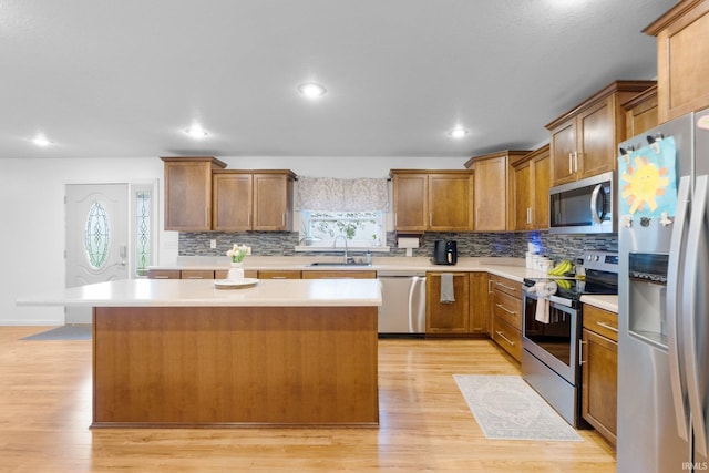 914 W 300 S, Bluffton, IN 46714 - kitchen with appliances with stainless steel finishes, a sink, light countertops, light wood finished floors, and recessed lighting