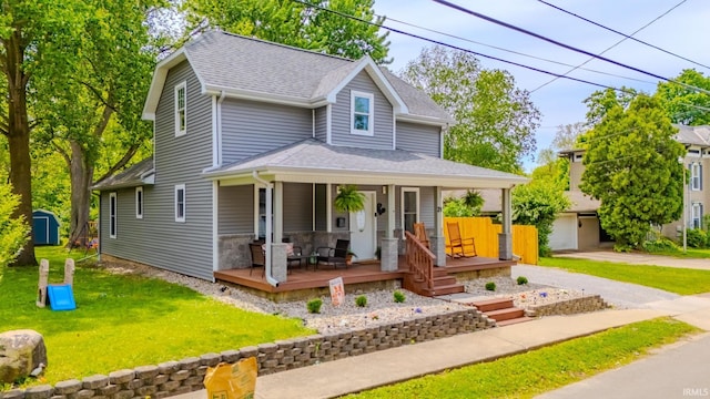 21 Noble St, Wabash, IN 46992 - view of front of house featuring a shingled roof, covered porch, a front lawn, and an outdoor structure
