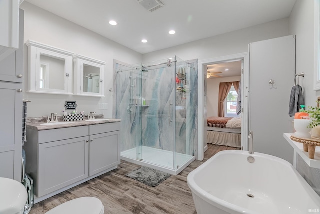 21 Noble St, Wabash, IN 46992 - ensuite bathroom with a marble finish shower, wood finished floors, recessed lighting, vanity, and toilet