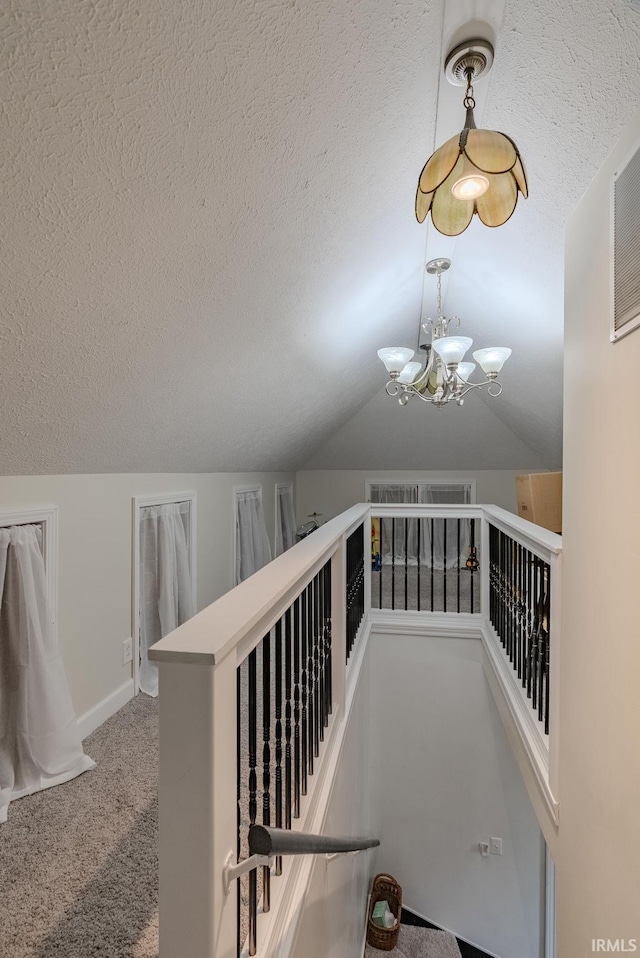 21 Noble St, Wabash, IN 46992 - stairway with a textured ceiling, carpet, vaulted ceiling, a chandelier, and baseboards