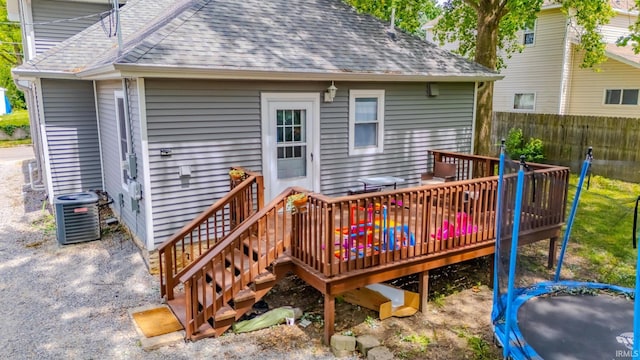 21 Noble St, Wabash, IN 46992 - back of house with a trampoline, central AC unit, roof with shingles, and a deck