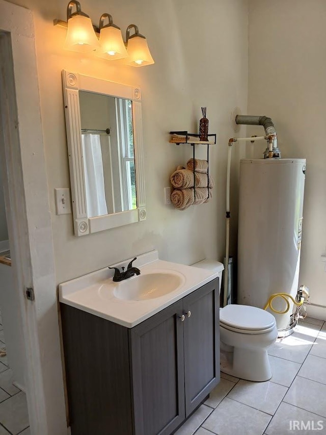 1237 E Illinois St, Evansville, IN 47711 - bathroom featuring gas water heater, tile patterned flooring, vanity, and toilet