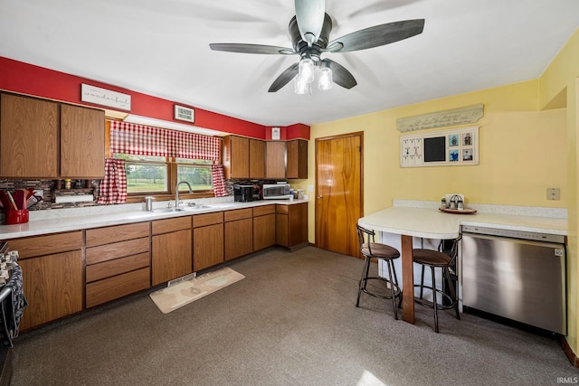 18377 Dunn Rd, South Bend, IN 46637 - kitchen featuring dishwasher, a sink, brown cabinets, and light countertops