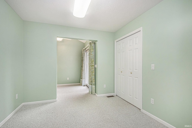 18586 Pauls Way S, Bend, IN 46637 - unfurnished bedroom with carpet, baseboards, a closet, and a textured ceiling