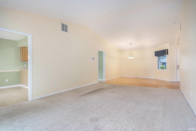 18586 Pauls Way S, Bend, IN 46637 - unfurnished room with light colored carpet, vaulted ceiling, and baseboards