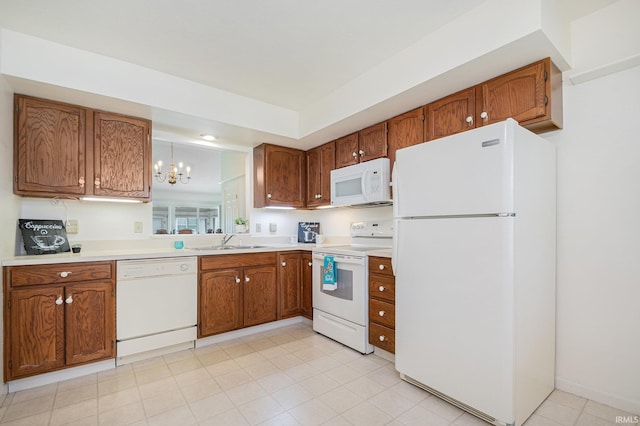 5843 Durham Ct, South Bend, IN 46614 - kitchen featuring white appliances, a sink, brown cabinets, and light countertops