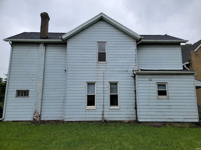 826 E Jefferson Blvd, Fort Wayne, IN 46803 - view of property exterior featuring a chimney and a yard