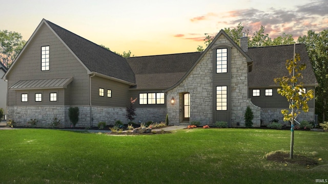 447 E Basalt Dr, Huntertown, IN 46748 - view of front of property with stone siding, a yard, and a chimney