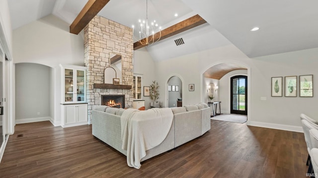 447 E Basalt Dr, Huntertown, IN 46748 - living room with a chandelier, beamed ceiling, a stone fireplace, arched walkways, and high vaulted ceiling