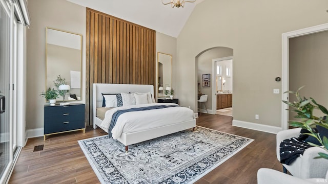 447 E Basalt Dr, Huntertown, IN 46748 - bedroom with arched walkways, high vaulted ceiling, wood finished floors, baseboards, and ensuite bath