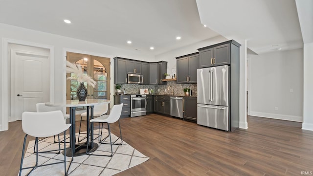 447 E Basalt Dr, Huntertown, IN 46748 - kitchen with appliances with stainless steel finishes, tasteful backsplash, dark wood finished floors, recessed lighting, and baseboards