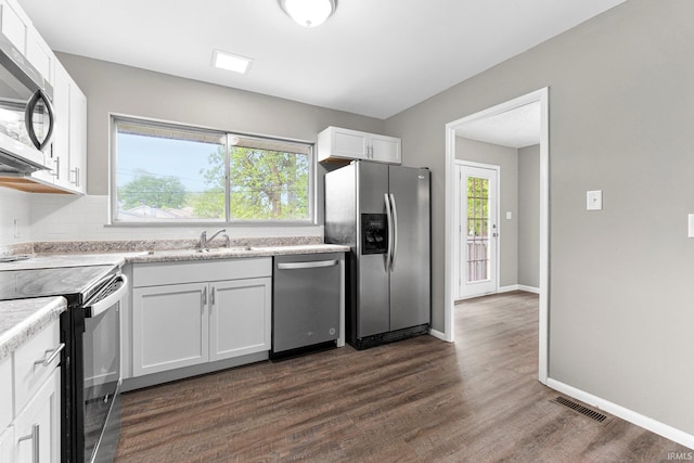 1024 Tulip Tree Rd, Fort Wayne, IN 46825 - kitchen with appliances with stainless steel finishes, light countertops, a sink, white cabinetry, and dark wood finished floors