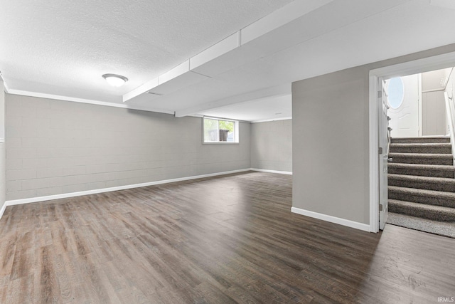 1024 Tulip Tree Rd, Fort Wayne, IN 46825 - basement with baseboards, wood finished floors, a textured ceiling, and stairway