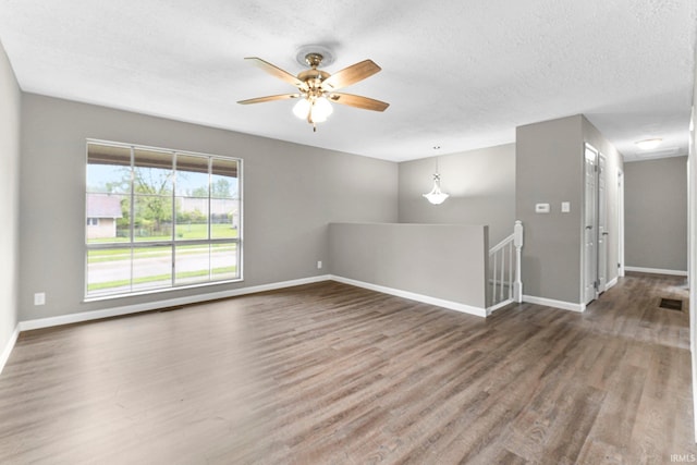 1024 Tulip Tree Rd, Fort Wayne, IN 46825 - spare room featuring wood finished floors, a ceiling fan, baseboards, and a textured ceiling