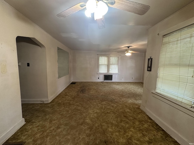 539 NE 9th St, Linton, IN 47441 - carpeted empty room with a ceiling fan, baseboards, and arched walkways