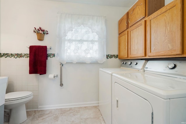 404 S Maple St, Greentown, IN 46936 - laundry room with washer and clothes dryer, tile walls, and light tile patterned floors