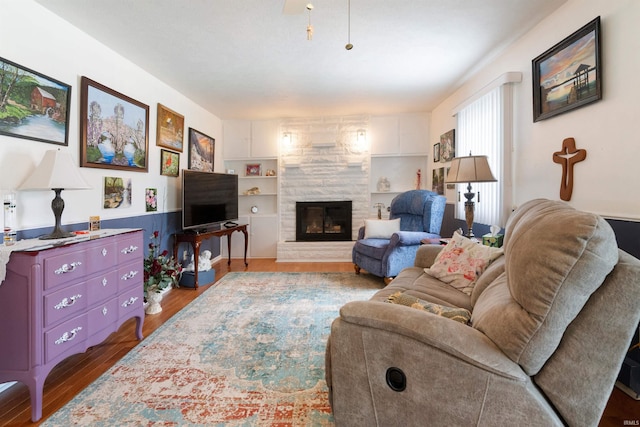 404 S Maple St, Greentown, IN 46936 - living room featuring a glass covered fireplace, wood finished floors, and built in features