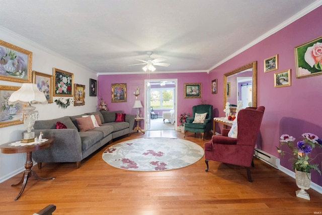404 S Maple St, Greentown, IN 46936 - living area with baseboard heating, ceiling fan, wood finished floors, ornamental molding, and baseboards