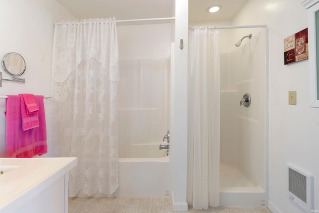 404 S Maple St, Greentown, IN 46936 - bathroom with vanity, heating unit, tile patterned flooring, and shower / bath combo with shower curtain