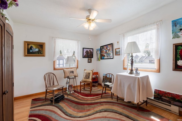 404 S Maple St, Greentown, IN 46936 - sitting room with a baseboard heating unit, healthy amount of natural light, and wood finished floors