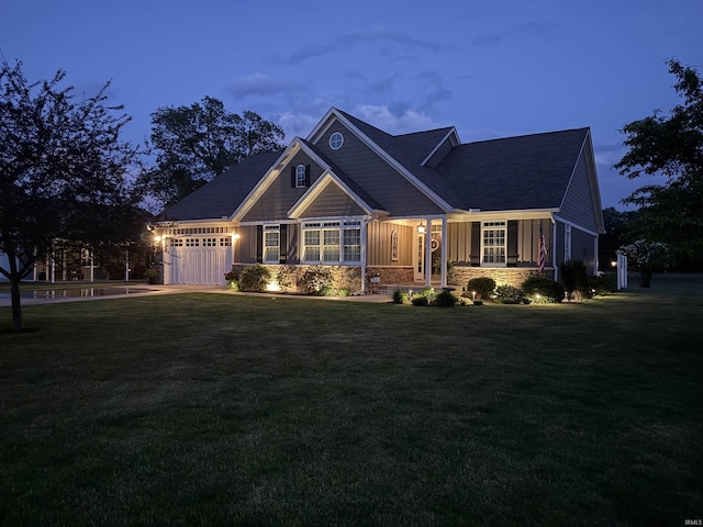 4968 W Campbell St, North Judson, IN 46366 - view of front of house with an attached garage, a front lawn, and board and batten siding