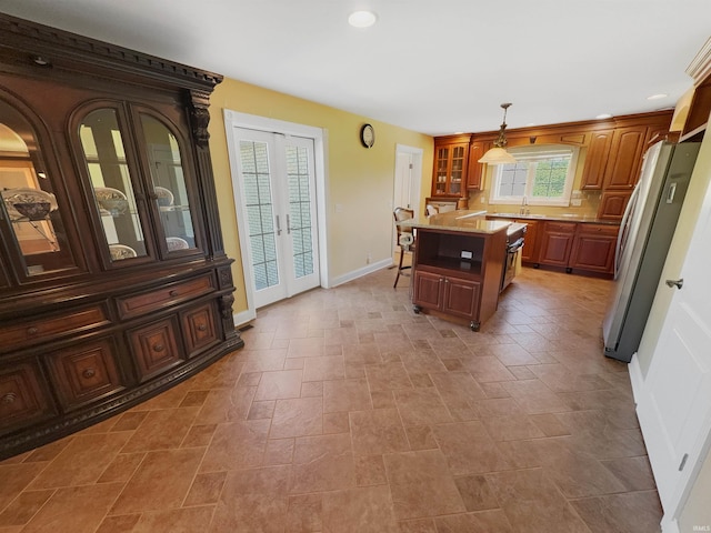 6359 E County Road 1900 N, Dale, IN 47523 - kitchen with freestanding refrigerator, stone tile flooring, a sink, glass insert cabinets, and light countertops