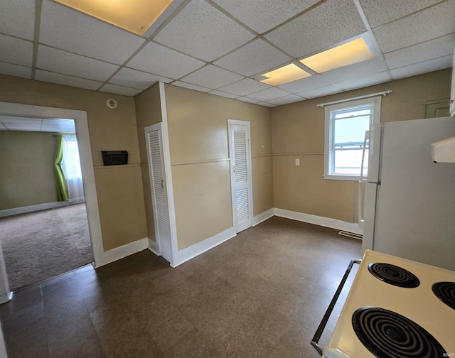 3403 Corbierre Ave, Evansville, IN 47712 - kitchen with a paneled ceiling, dark flooring, white appliances, and baseboards