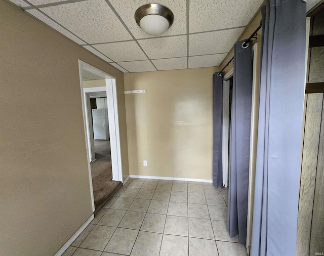 3403 Corbierre Ave, Evansville, IN 47712 - corridor featuring a paneled ceiling, light tile patterned floors, and baseboards