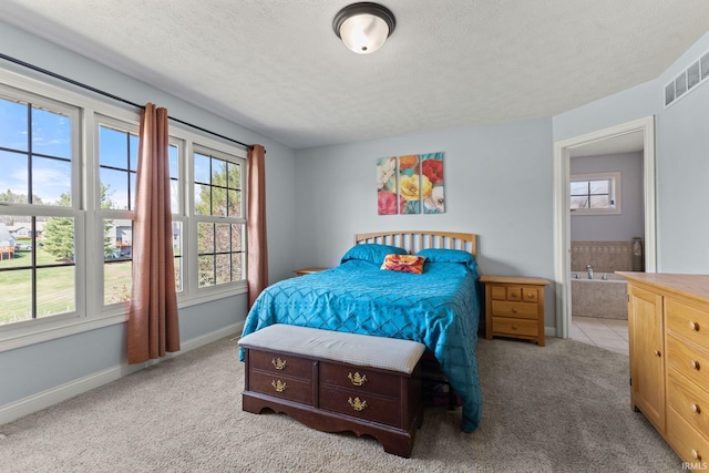 6093 Boulder Ct, Columbus, IN 47201 - bedroom featuring multiple windows, carpet flooring, a textured ceiling, baseboards, and ensuite bath