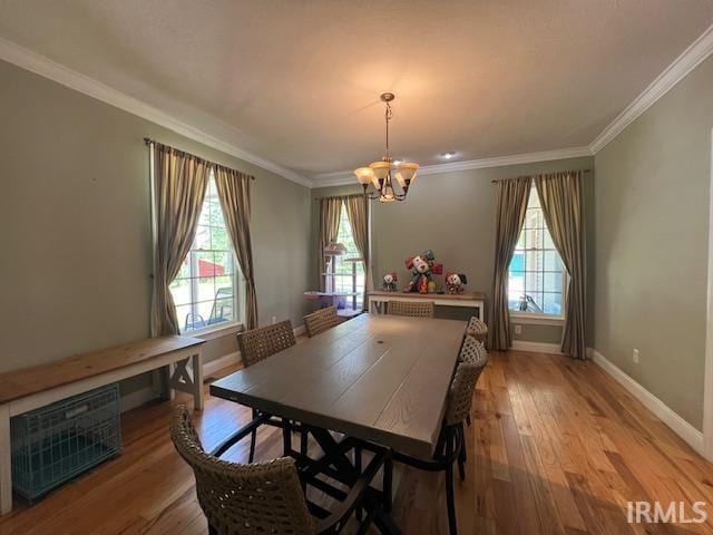 3638 N 1500 W Rd, Linton, IN 47441 - dining space featuring a chandelier, healthy amount of natural light, light wood-style floors, crown molding, and baseboards