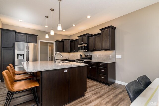 12475 Speranza Dr, Fort Wayne, IN 46818 - kitchen featuring a sink, stainless steel appliances, light wood-style floors, recessed lighting, and baseboards