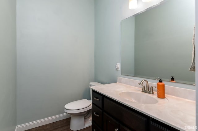12475 Speranza Dr, Fort Wayne, IN 46818 - half bath featuring toilet, vanity, wood finished floors, and baseboards