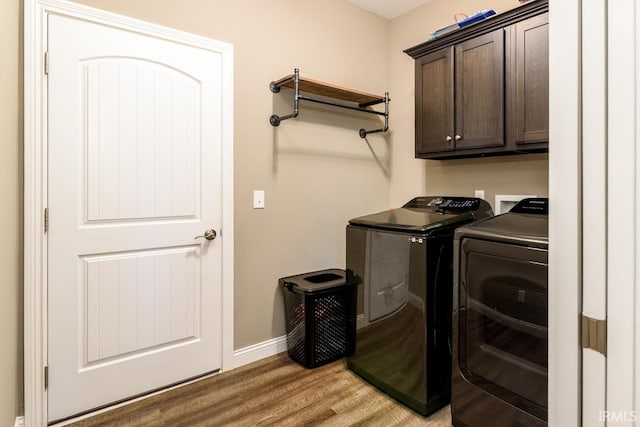 12475 Speranza Dr, Fort Wayne, IN 46818 - washroom featuring cabinet space, washing machine and clothes dryer, light wood finished floors, and baseboards