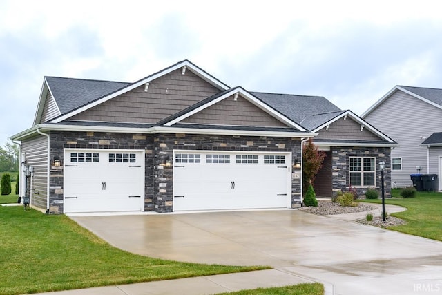 12475 Speranza Dr, Fort Wayne, IN 46818 - craftsman house featuring concrete driveway, stone siding, a garage, and a front lawn
