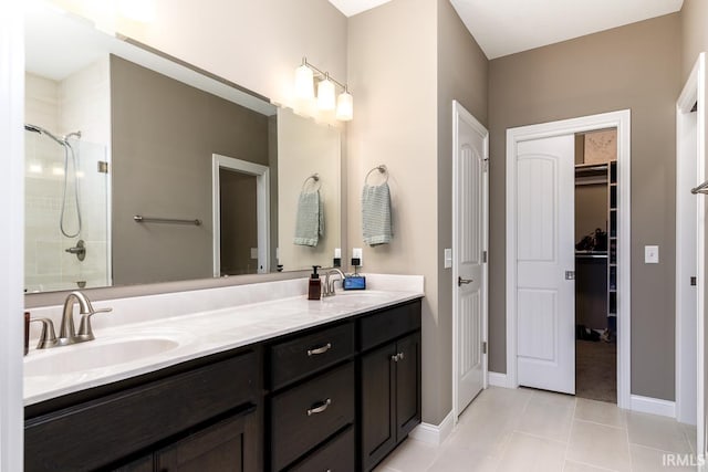 12475 Speranza Dr, Fort Wayne, IN 46818 - bathroom featuring a tile shower, double vanity, tile patterned floors, and a spacious closet
