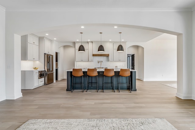 12318 Rain Lily Ct, Fort Wayne, IN 46814 - kitchen with high quality fridge, arched walkways, decorative backsplash, light countertops, and recessed lighting