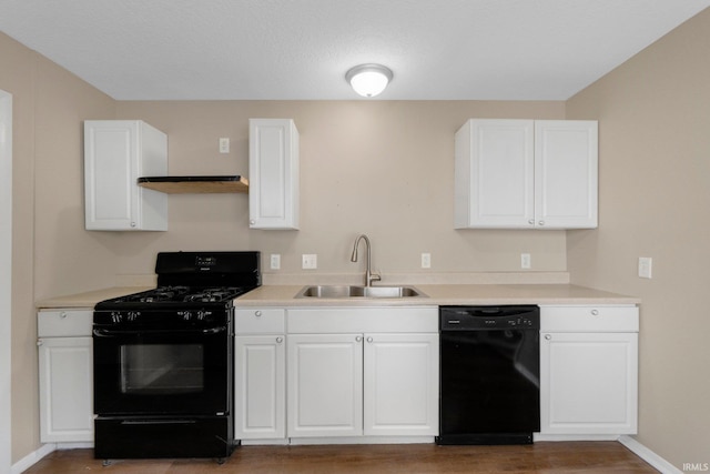 1510 W 4th St, Fort Wayne, IN 46808 - kitchen with black appliances, a sink, white cabinets, and light wood-style floors