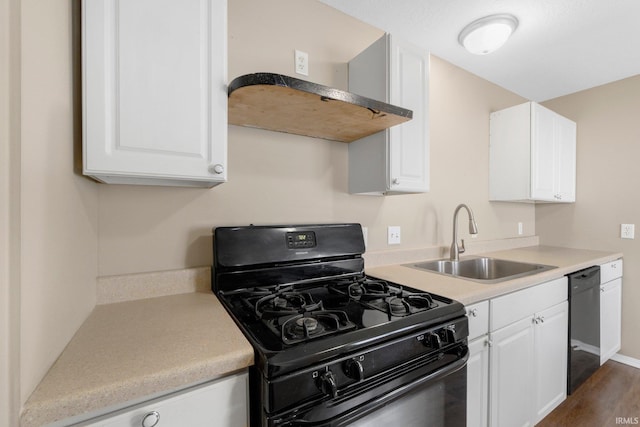 1510 W 4th St, Fort Wayne, IN 46808 - kitchen featuring black appliances, a sink, white cabinets, light countertops, and wall chimney range hood