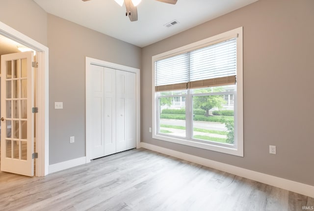 1590 S Renwick Blvd, Bloomington, IN 47401 - unfurnished bedroom with light wood finished floors, baseboards, a closet, and a ceiling fan