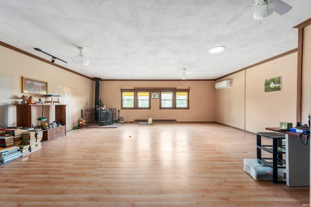 5668 E 500 S, Lynn, IN 47355 - unfurnished living room featuring ornamental molding, a wood stove, a wall mounted air conditioner, ceiling fan, and wood finished floors
