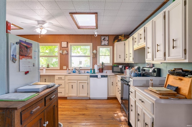 5668 E 500 S, Lynn, IN 47355 - kitchen with dishwasher, stainless steel electric range, black microwave, a sink, and light wood-type flooring